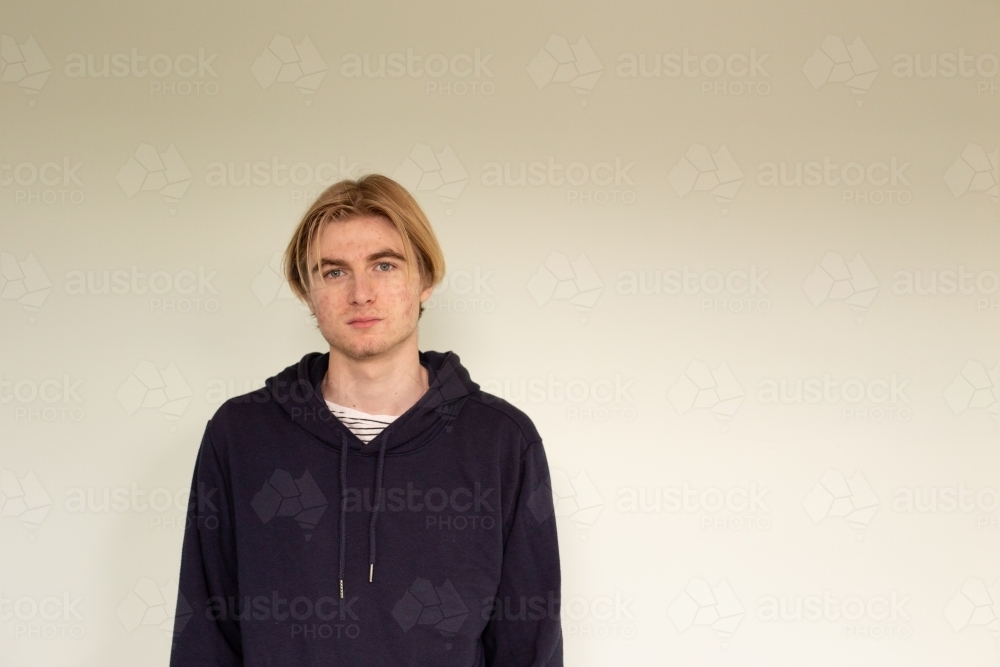 Headshot of teenage boy wearing black hoodie - Australian Stock Image