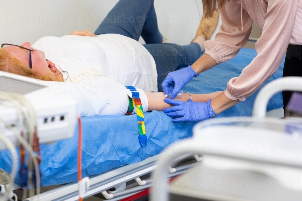 health centre with phlebotomist preparing to take blood - Australian Stock Image