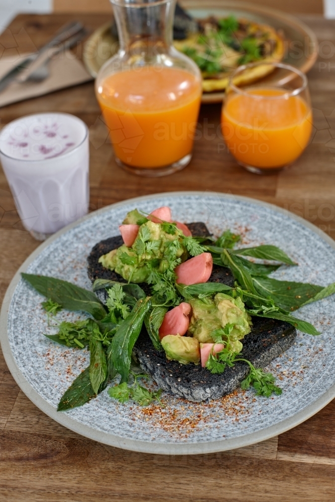 Healthy organic vegan food and drinks on wooden table - Australian Stock Image