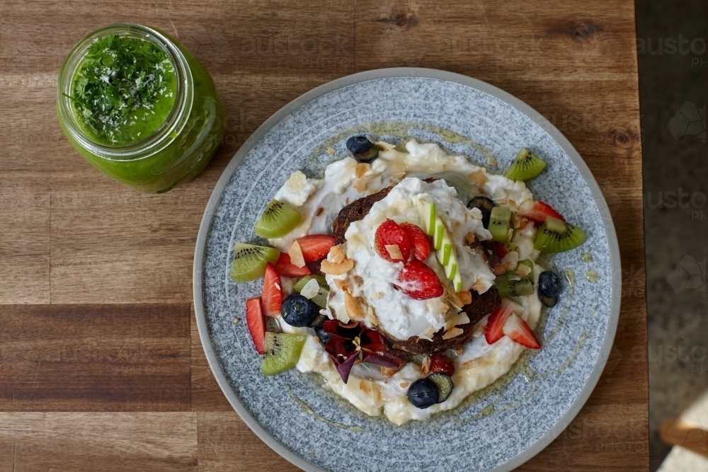 Healthy organic vegan food and drinks on wooden table - Australian Stock Image