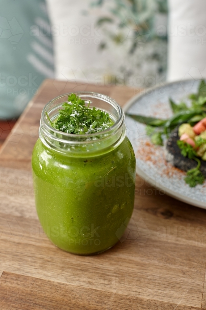 Healthy organic vegan food and drinks on wooden table - Australian Stock Image