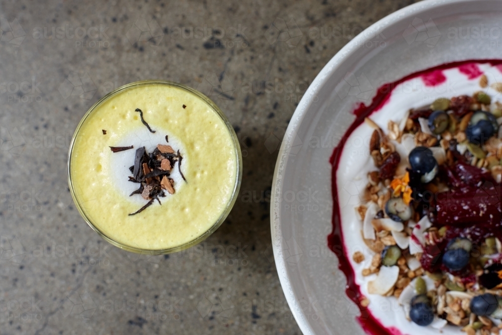 Healthy porridge served with hot beverage in vegetarian cafe - Australian Stock Image