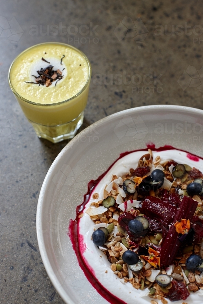 Healthy porridge served with hot beverage in vegetarian cafe - Australian Stock Image