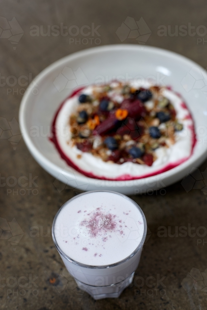 Healthy porridge served with hot beverage in vegetarian cafe - Australian Stock Image