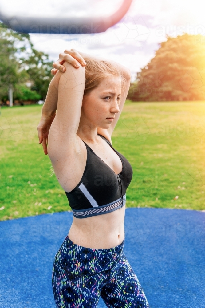 Healthy teenage girl training outdoors - Australian Stock Image