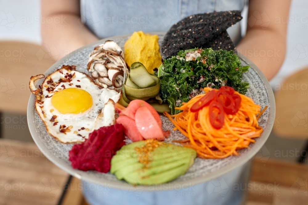Healthy vegetarian meal being served by waiter - Australian Stock Image