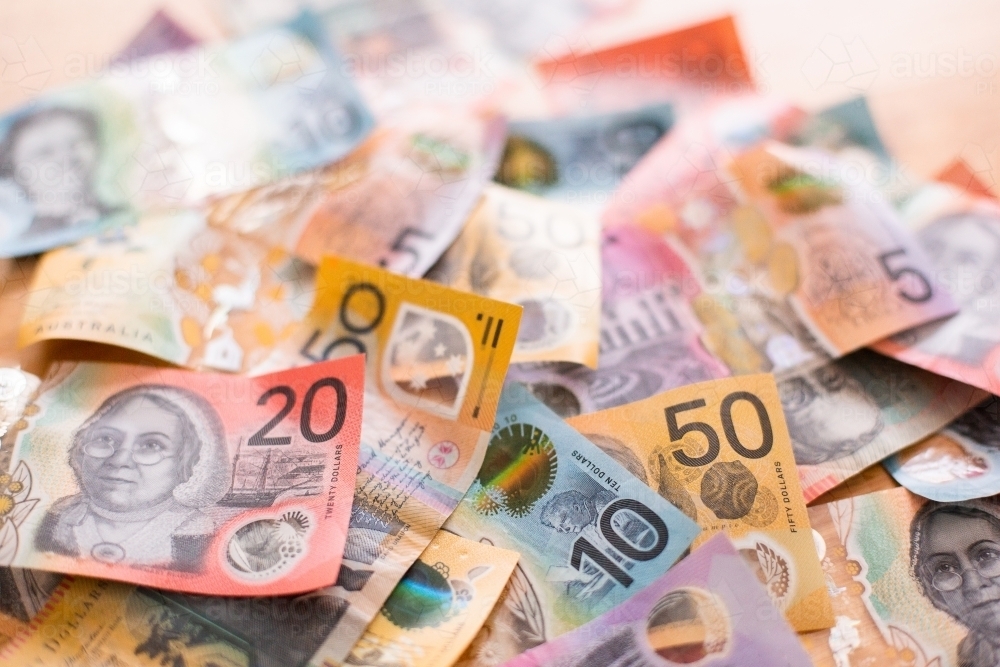 heap of Australian currency notes on a table top - Australian Stock Image