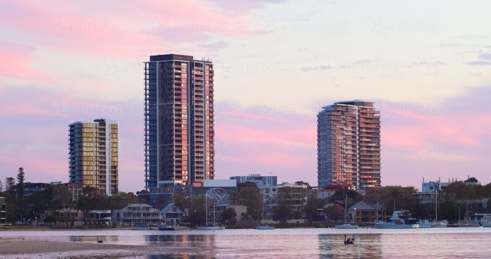 High-rise apartment buildings in Applecross at sunset, with the Swan River in the foreground. - Australian Stock Image