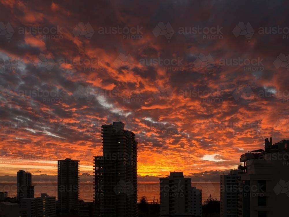 High-rise buildings silhouetted against a sunset sky - Australian Stock Image
