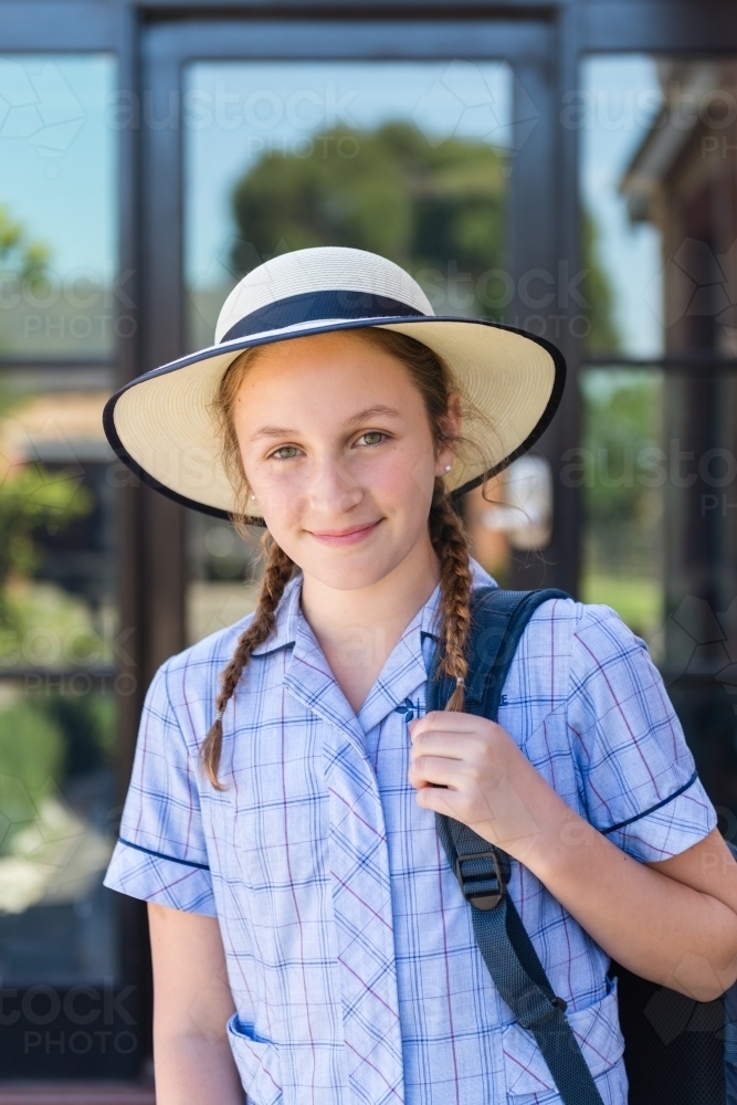 high school girl in school uniform with bag - Australian Stock Image