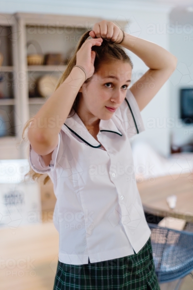 high school student doing hair in the morning - Australian Stock Image