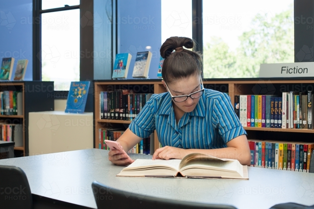 High school student studying in the library - Australian Stock Image