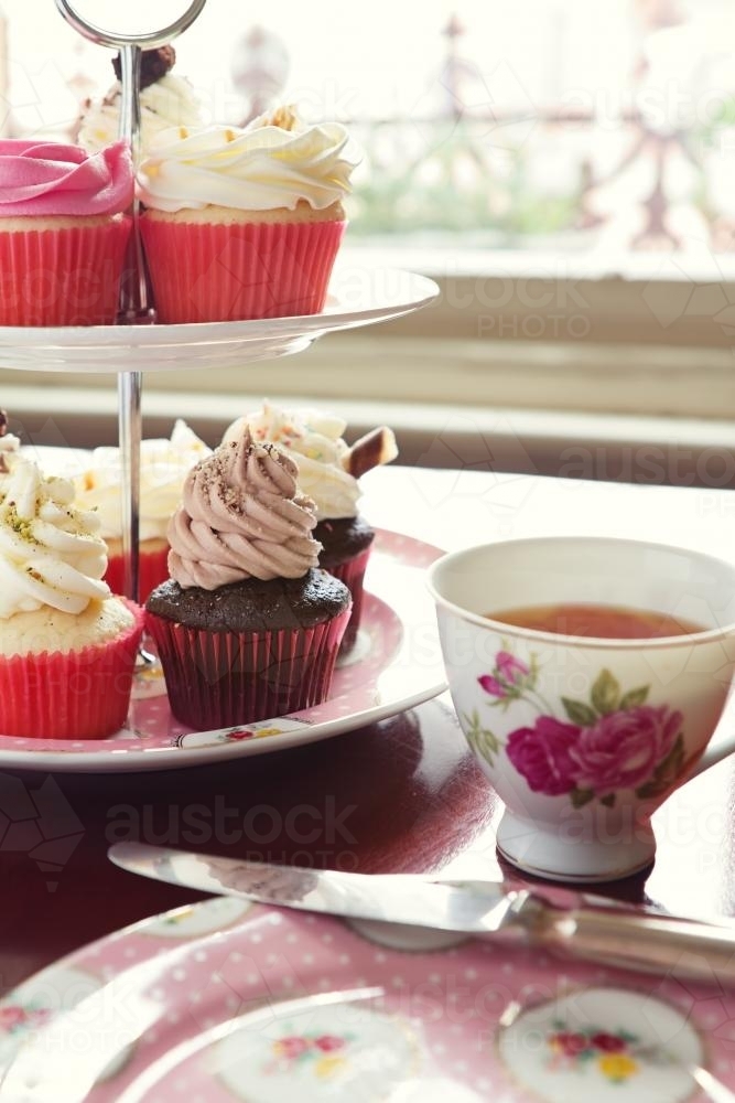 High tea with cupcake stand and cup of tea in vintage crockery - Australian Stock Image