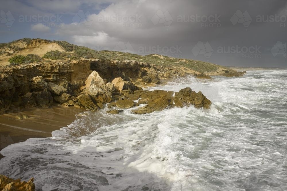 High tide waves crashing on the beach and rocks - Australian Stock Image