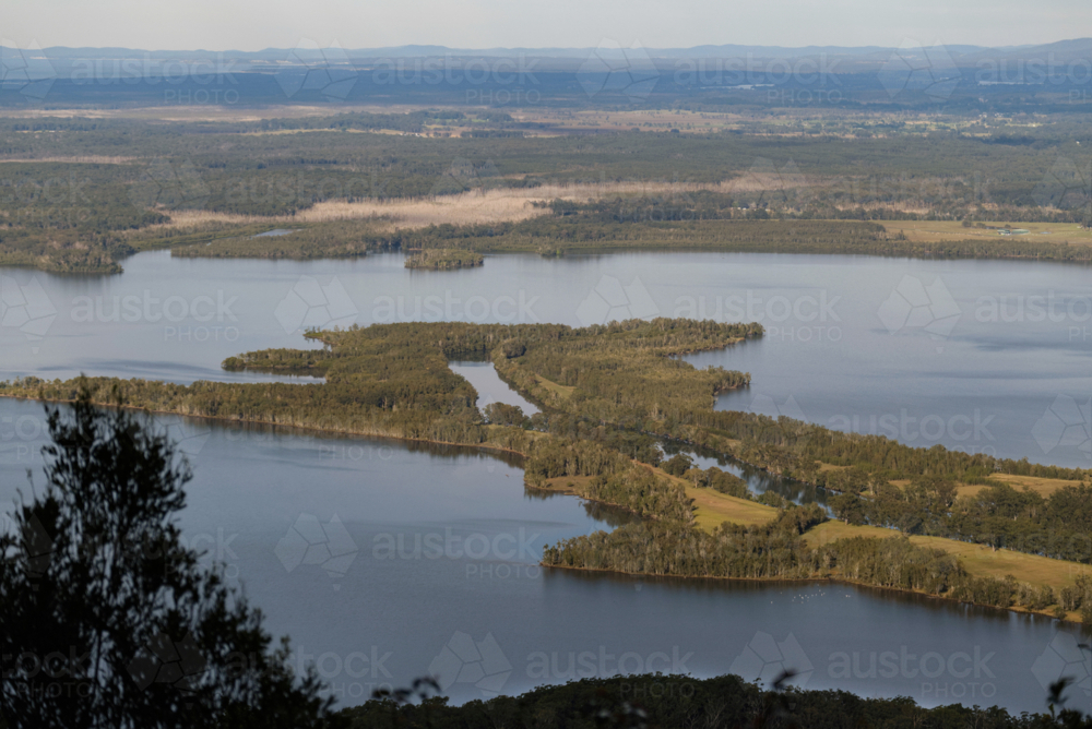 High view of river reach flowing into lake on a sunny day - Australian Stock Image