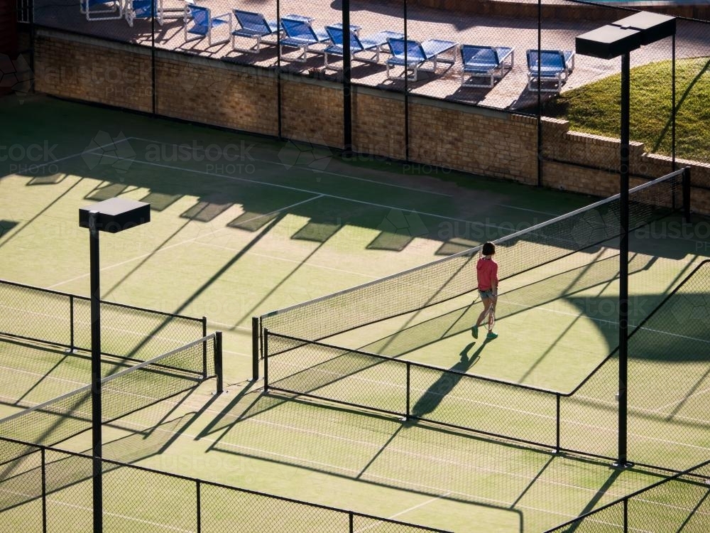 High view of tennis courts with long shadows - Australian Stock Image