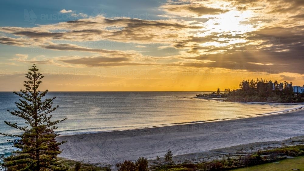 High view overlooking beach at sunrise - Australian Stock Image