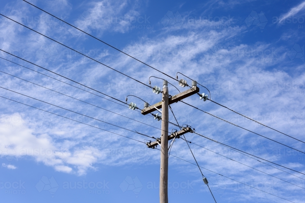 High voltage power transmission tower on blue sky background,  electricity distribution. - Australian Stock Image