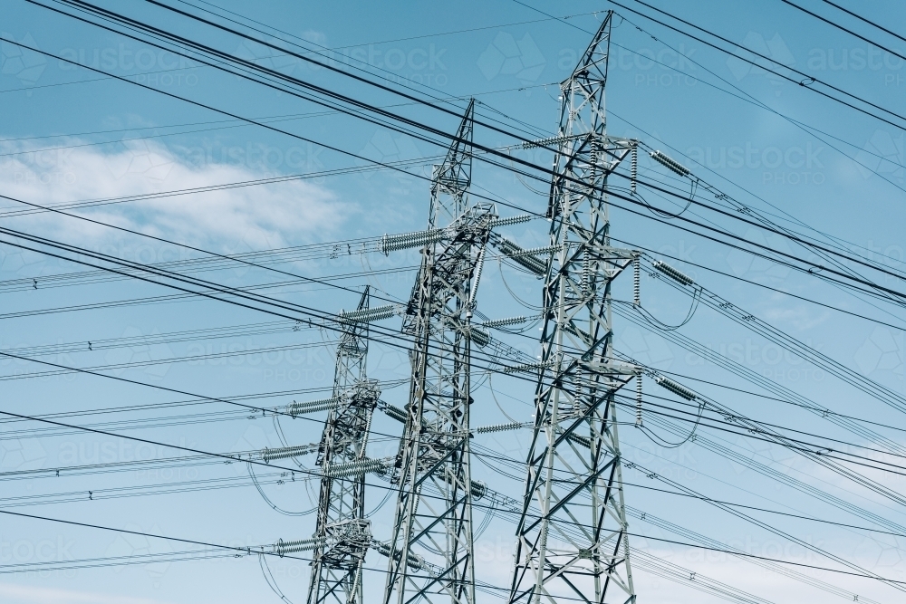 High voltage power transmission tower on blue sky background,  electricity distribution. - Australian Stock Image
