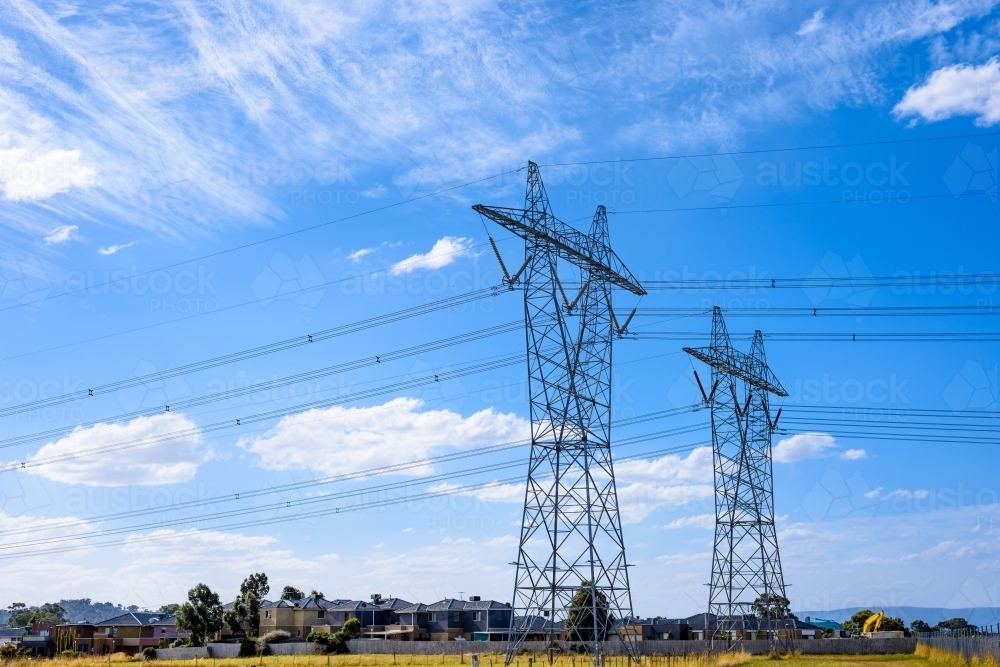 High voltage power transmission tower on blue sky background,  electricity distribution. - Australian Stock Image