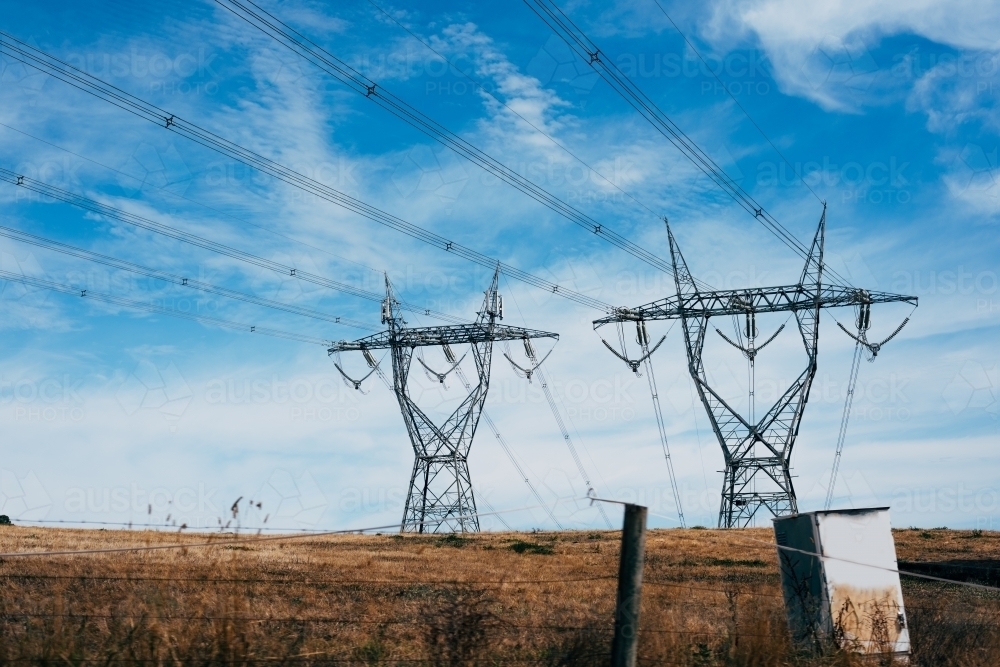 High voltage power transmission tower on blue sky background,  electricity distribution. - Australian Stock Image