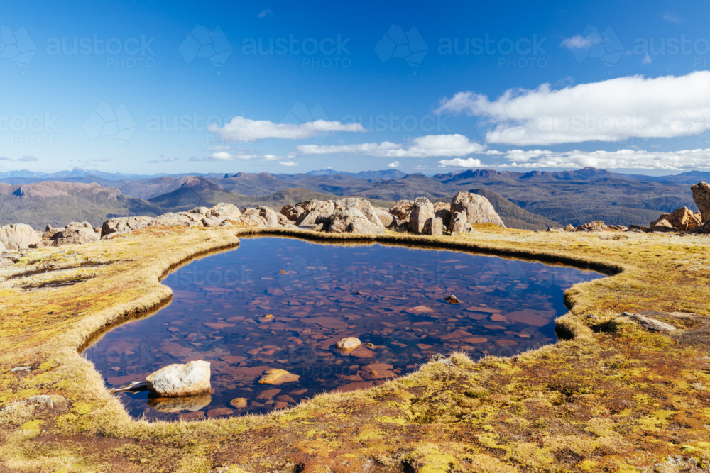 Highest tarn in Tasmania atop the summit of Mt Ossa on a clear autumn afternoon in Cradle Mountain - Australian Stock Image