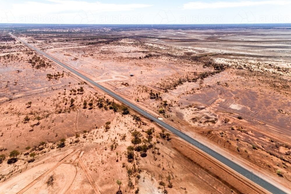 Highway cuts through western Queensland in drought. - Australian Stock Image