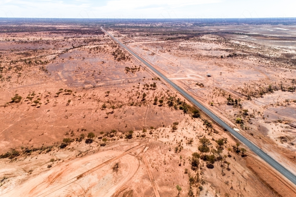 Highway cuts through western Queensland in drought. - Australian Stock Image