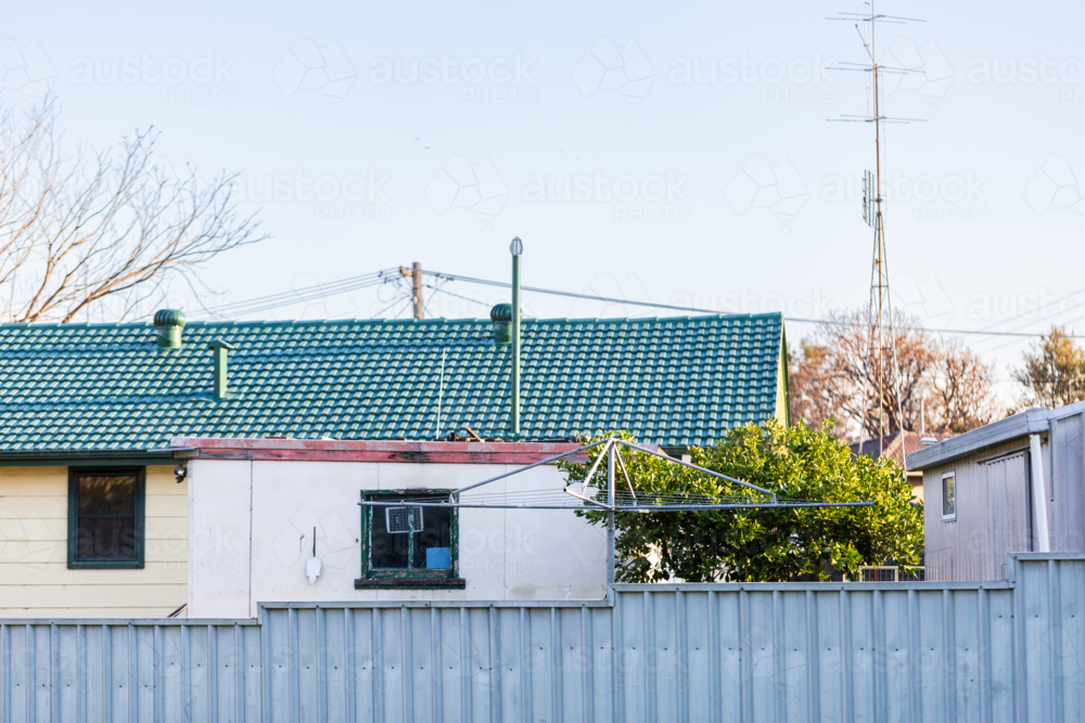 Hills hoist washing line in backyard of home with fruit tree - Australian Stock Image
