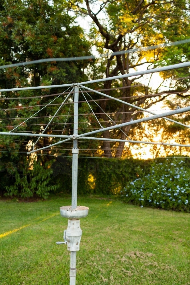Hills Hoist washing line on neat lawn grass on autumn afternoon on farm - Australian Stock Image