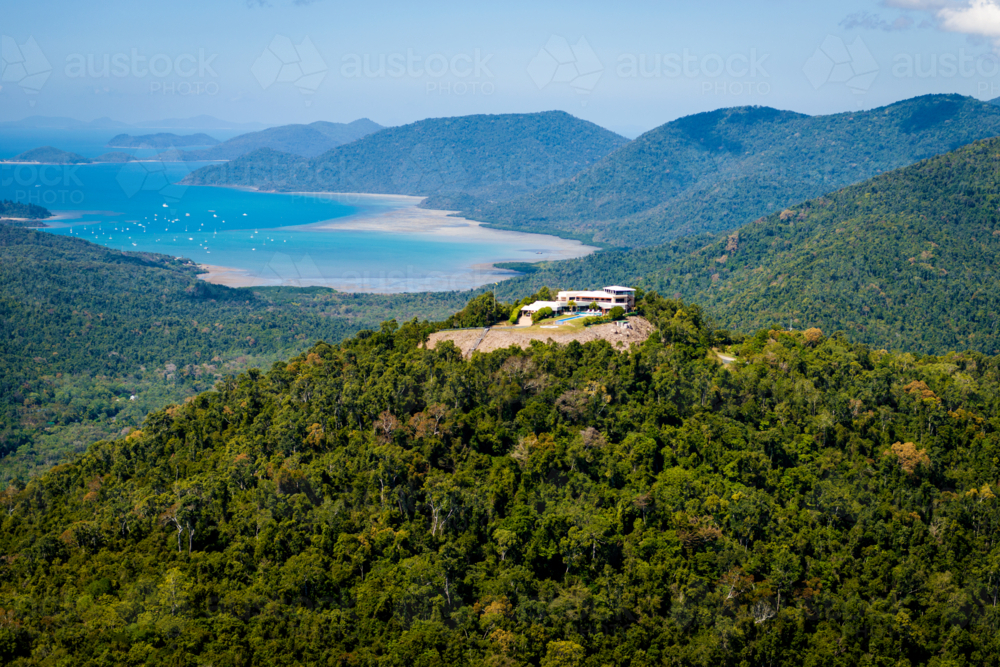 Hilltop house overlooking bays and forest near Airlie Beach - Australian Stock Image