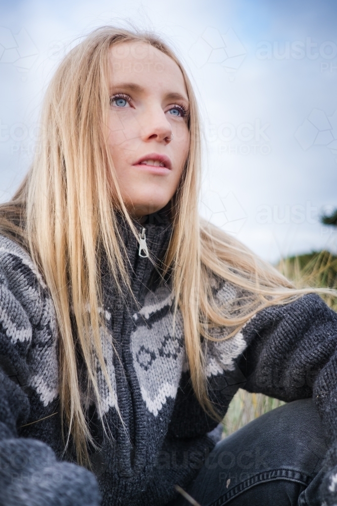 Hip blonde girl in a cosy woollen jumper - Australian Stock Image