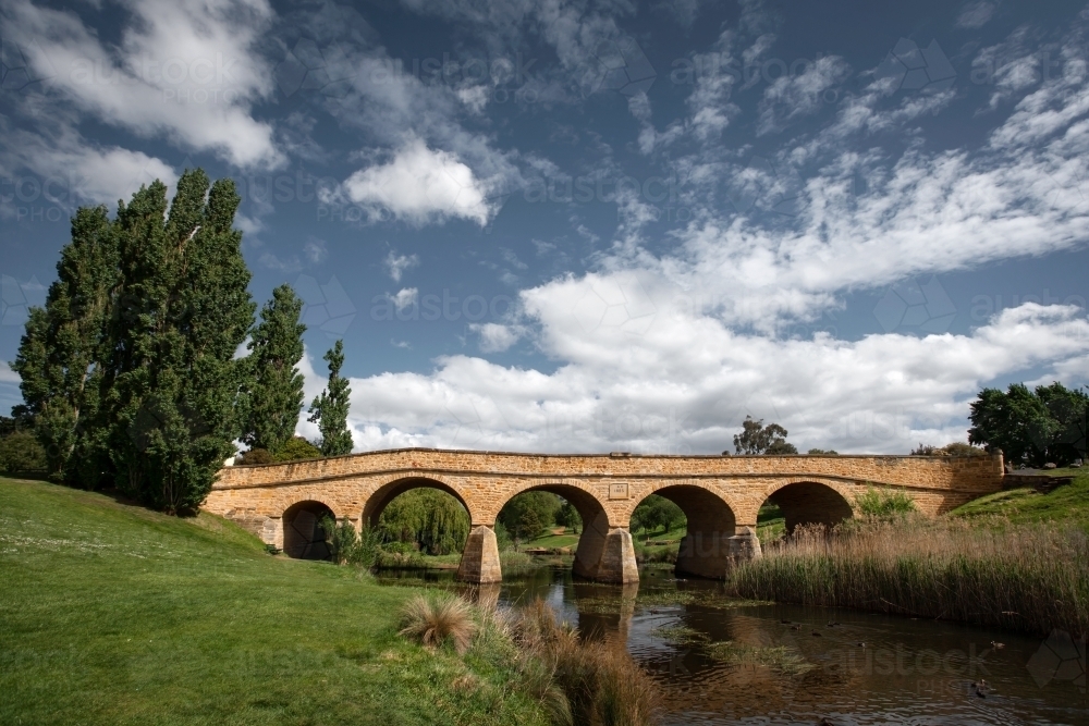 historic arch bridge over a river - Australian Stock Image