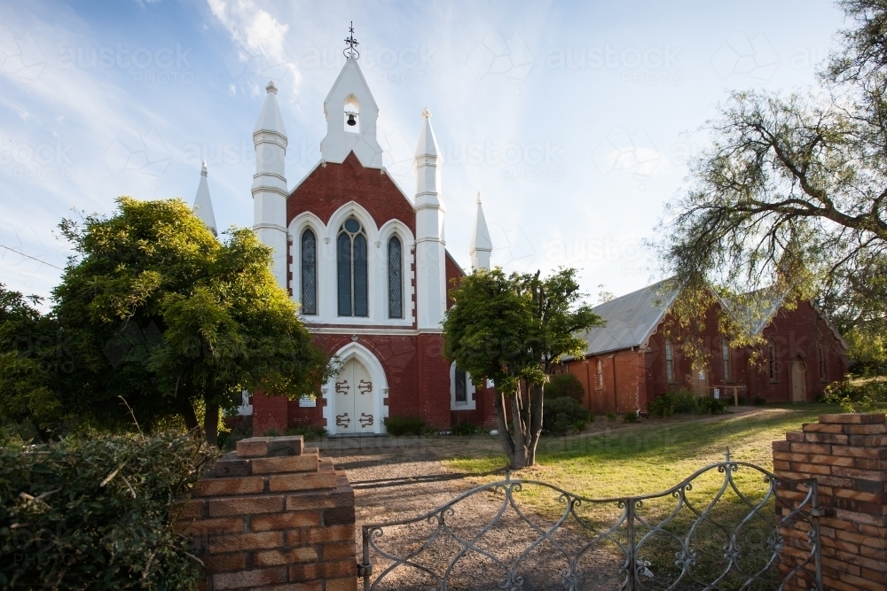 historic church and grounds behind a wrought iron gate - Australian Stock Image