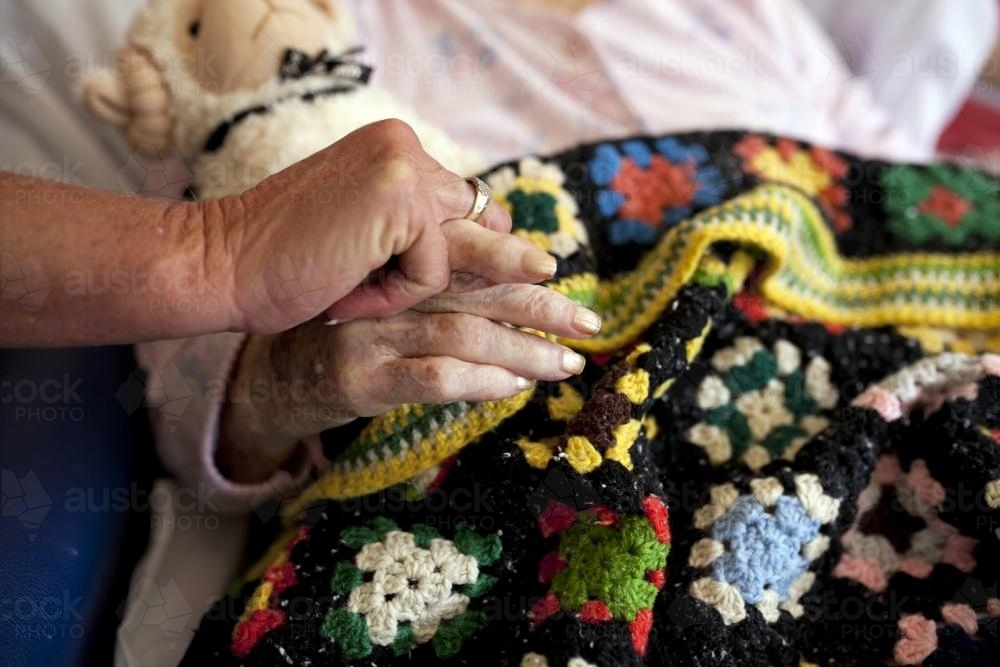 Holding hands with elderly patient - Australian Stock Image