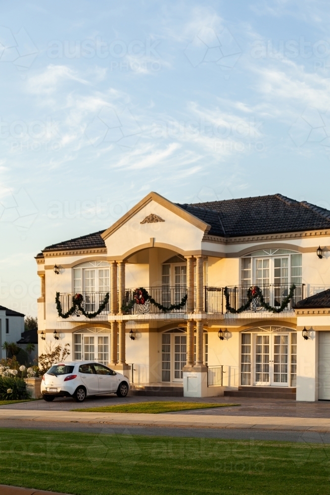 Home in afternoon light with wreath and tinsel decorating house for Christmas - Australian Stock Image