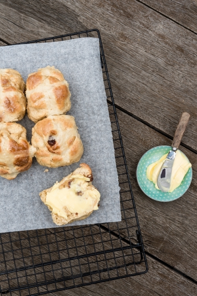 home made hot cross buns with butter - Australian Stock Image