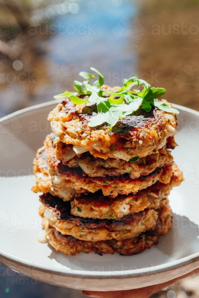 Homemade Zucchini fritters next to river - Australian Stock Image