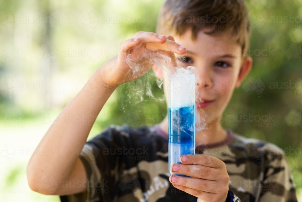 Homeschool kid doing science experiment with dry ice, water and soap - Australian Stock Image