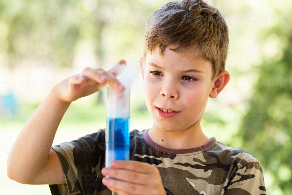 Homeschool kid doing science experiment with dry ice, water and soap - Australian Stock Image