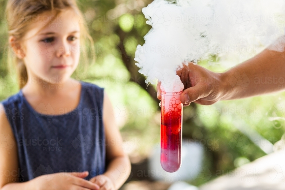 Homeschool kid doing science experiment with dry ice, water and soap - Australian Stock Image