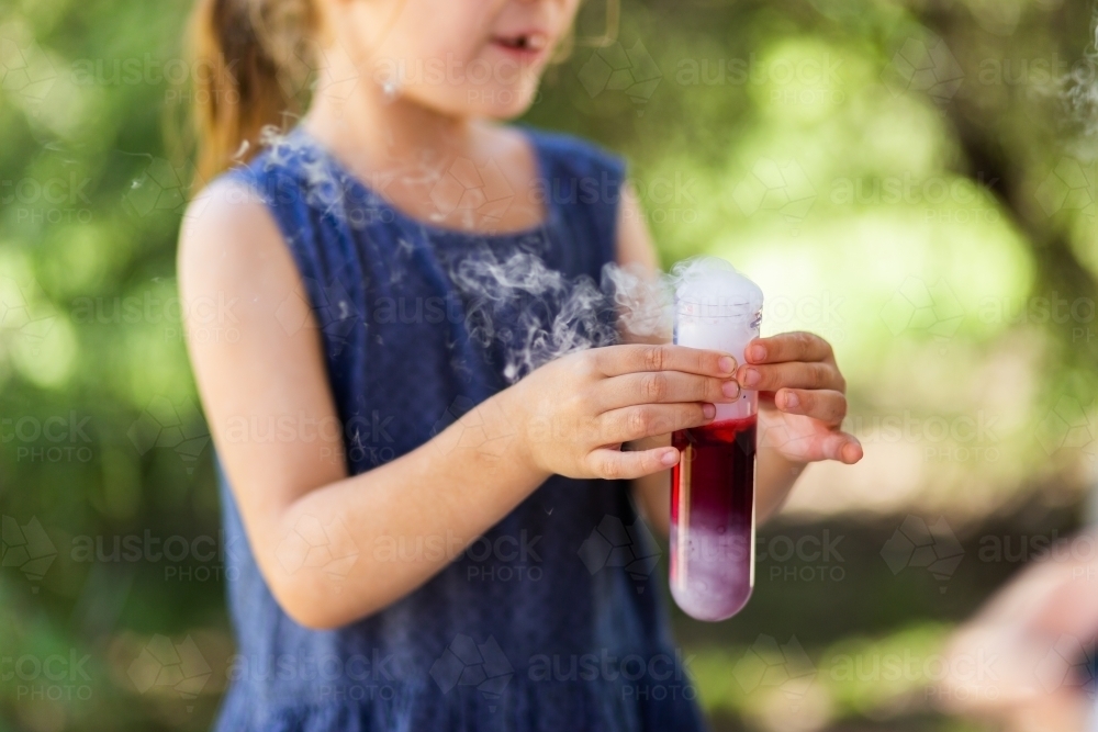 Homeschool kid doing science experiment with dry ice, water and soap - Australian Stock Image