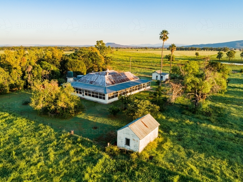 homestead in farm, surrounded by green paddocks after rain broke the drought - Australian Stock Image