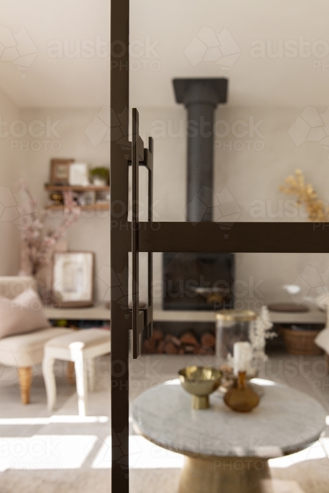 Homey living room with fireplace and designer furniture - Australian Stock Image