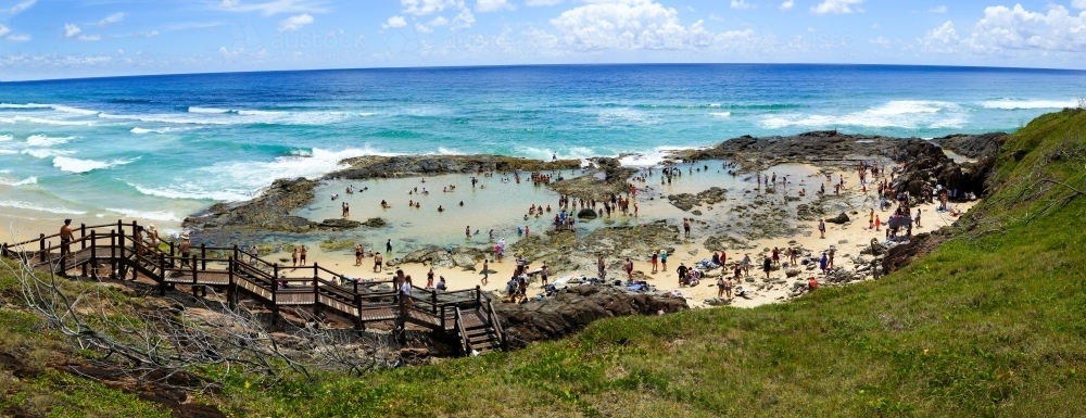 Hordes of people enjoying swimming in Champagne Pools on K'gari Fraser Island, QLD - Australian Stock Image