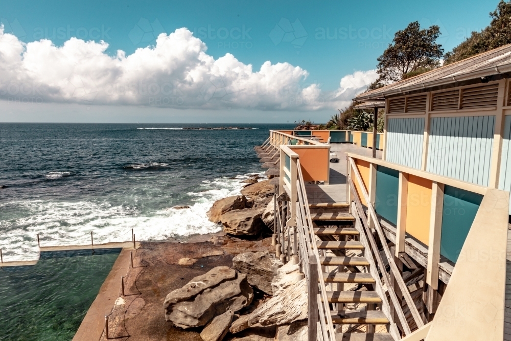 horizontal shot of a beach with, stairs, waves, trees on a sunny day - Australian Stock Image