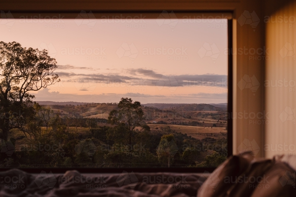 Horizontal shot of a bedside window with trees and mountain background - Australian Stock Image