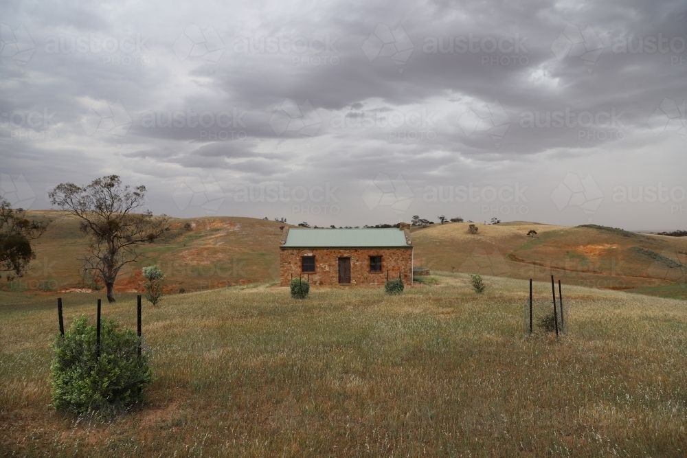 Lone brick house on a hilltop - Australian Stock Image