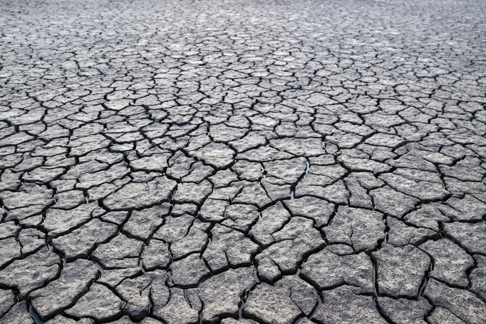 Horizontal shot of a dry cracked soil dirt - Australian Stock Image