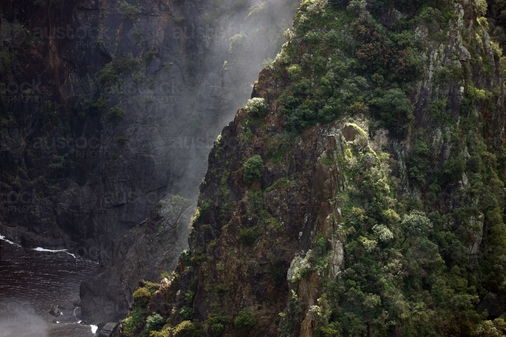 Horizontal shot of a foggy cliff in ravine - Australian Stock Image